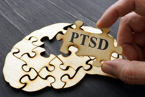 PTSD Post Traumatic Stress written on the puzzle.