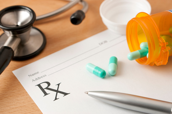 prescription medication, pad, and stethoscope; Massachusetts workers' compensation lawyer